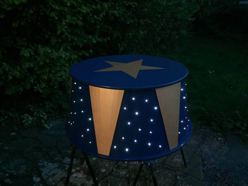 Circus stool, exterior night.